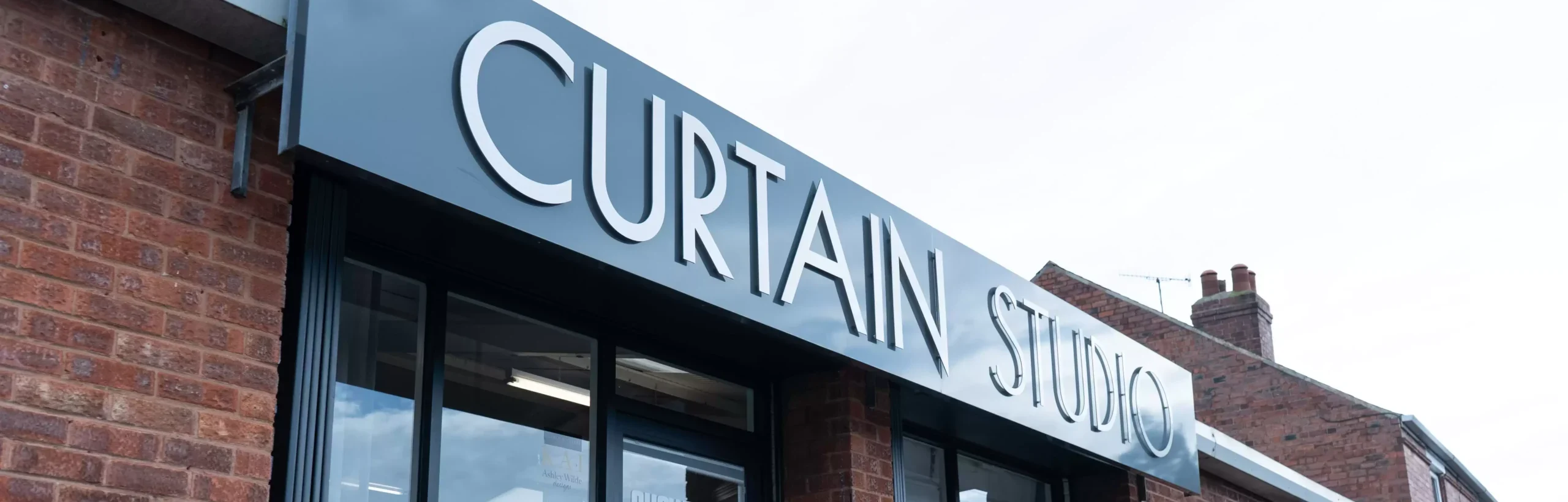 The Curtain Studio sign, which hangs above the entrance to their showroom.