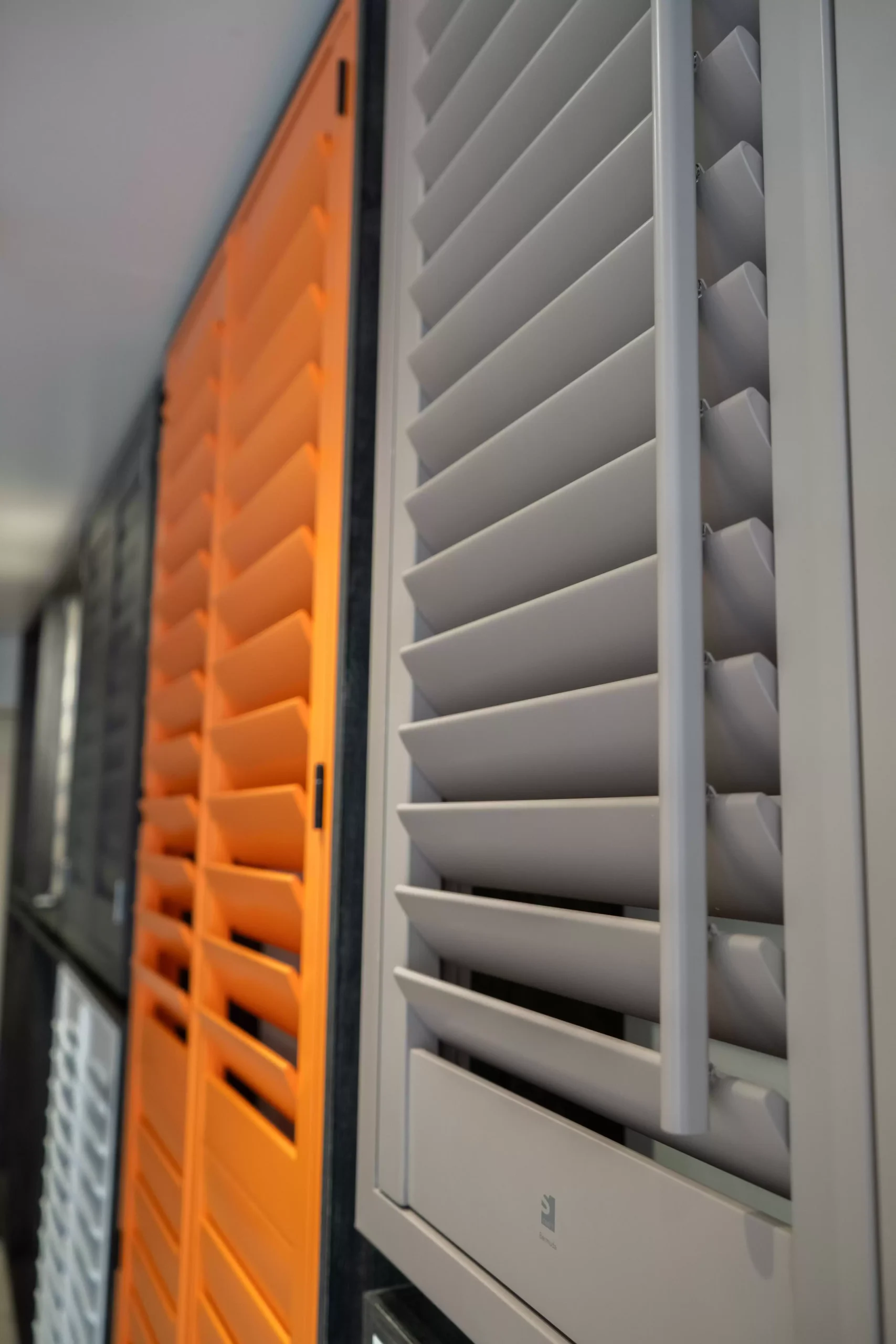 A close up of various styles of matte-painted wooden shutters.