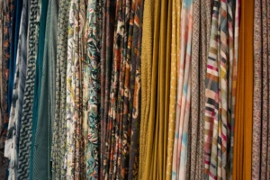 A selection of different fabrics, each different colours with various patterns.
