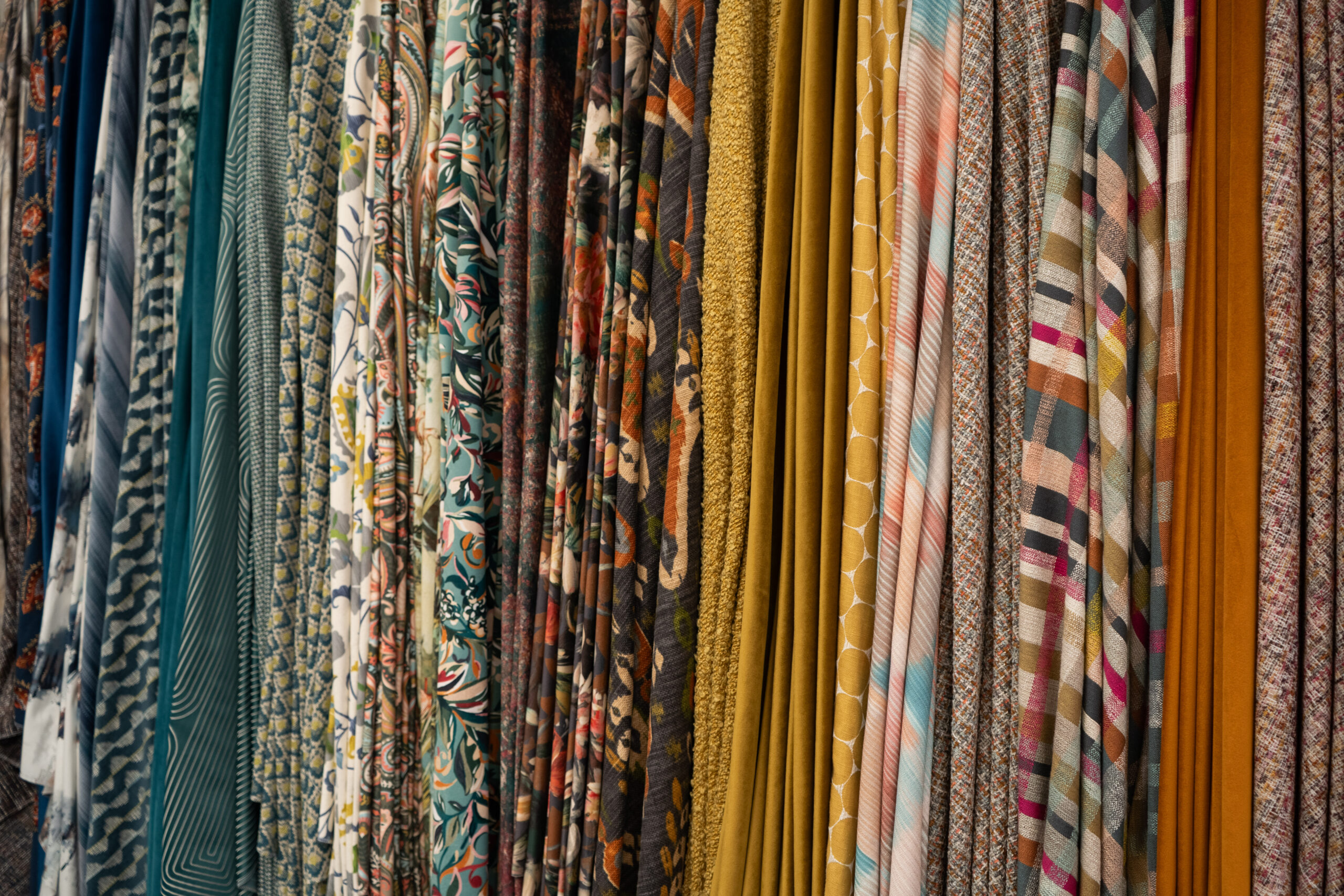 A selection of different fabrics, each different colours with various patterns.