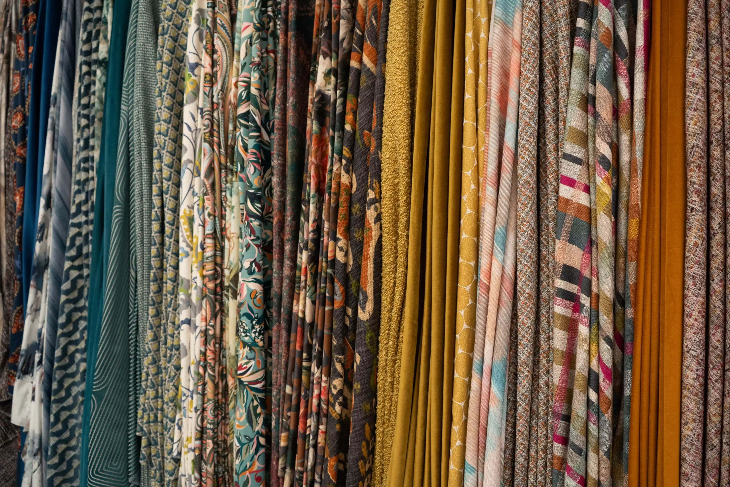 A selection of different fabrics, each different colours with various patterns.
