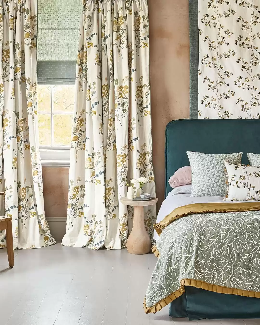 An image of a window covered by flower patterned curtains.