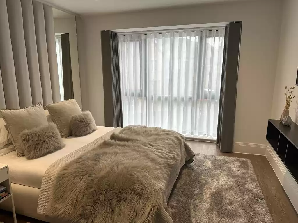 A bedroom decorated with grey furnishings.